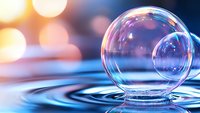 Transparent soap bubble resting on rippling water surface with soft bokeh lights in background creating dreamy atmospheric effect. Perfect for wellness and tranquility themes.