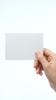 Female hand holding blank white card mockup on clean background for business branding and design projects.