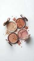 Cracked makeup powder compacts in warm nude and coral tones scattered with broken pieces on white background for beauty and cosmetics branding.
