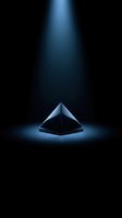 Metallic pyramid with blue spotlight illumination on dark background, suitable for corporate branding, technology concepts, and abstract design projects.