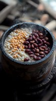 Traditional stone bowl filled with cooked barley and red kidney beans creating nutritious meal for healthy eating and vegetarian cuisine concepts.