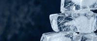Stacked ice cubes with water droplets on dark blue background, suitable for beverage, refreshment, and cooling product advertising.
