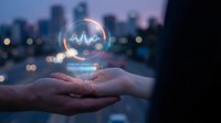 Hands holding glowing healthcare heartbeat pulse hologram over blurred city skyline at dusk for medical technology and digital health innovation concepts.
