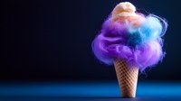 Cotton candy styled ice cream cone with colorful pink, purple and blue fluffy clouds on dark background, creative food photography concept for dessert menu.