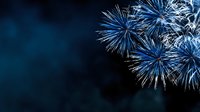 Spectacular blue fireworks exploding against dark night sky, creating festive atmosphere for celebrations, holidays, and special events.