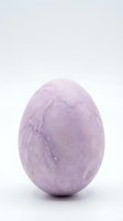 Purple speckled Easter egg isolated on white background for holiday decorations and seasonal design projects.