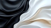 Elegant flowing silk fabric with smooth waves in black, white and beige tones creating luxurious textile background for fashion and interior design projects.