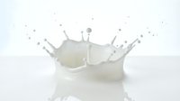 White milk splash crown with droplets on reflective surface creating dynamic liquid motion for dairy and beverage advertising campaigns.