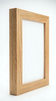 Wooden oak photo frame with empty white space isolated on white background, side angle view for home decor and mockup design use.