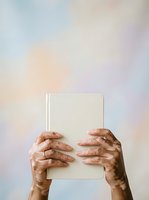 Mature hands holding blank white tablet against soft pastel gradient background, representing technology adoption, digital learning, and senior engagement with modern devices.