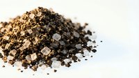 Pile of vermiculite mineral aggregate isolated on white background for gardening, construction and insulation applications in horticulture industry.