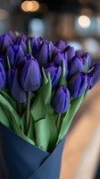 Fresh purple tulips in modern blue wrapper with soft bokeh background, close-up macro shot highlighting vibrant petals and green stems for floral design and spring decor.