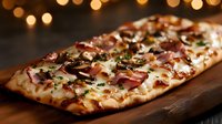 Homemade flatbread pizza topped with melted mozzarella, crispy bacon pieces, and fresh herbs served on rustic wooden board with warm bokeh lights in background.