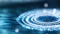 Glowing spiral of light particles creating dynamic motion trail against dark blue background, abstract energy flow with bokeh effect and depth of field.