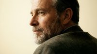 Mature man with gray beard and dark hair in profile, wearing olive sweater against neutral background. Suitable for healthcare, wellness, lifestyle and corporate projects.