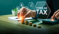 Business professional analyzing different types of tax categories with digital interface icons and coin stacks on desk for financial planning consultation.