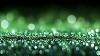 Magical green glitter background with bokeh effect and sparkling particles creating dreamy festive atmosphere. Defocused lights for holiday designs.
