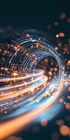 Glowing spiral light trails with orange and blue streaks creating dynamic motion effect against dark background, abstract technological concept with bokeh elements.