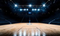 Empty basketball court with dramatic lighting from above, wooden floor reflecting spotlights, blue stadium seats in dark arena atmosphere. Professional sports venue.