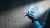 Hand holding glowing holographic car icon with blue light effect on concrete surface for automotive technology and digital innovation concepts.