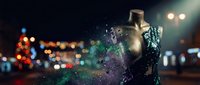 Mannequin torso dissolving into colorful particles and light trails against blurred city nightscape, representing fashion design, digital transformation, and retail concepts.