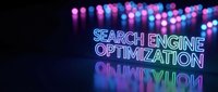Neon glowing text displaying search engine optimization concept with colorful bokeh lights and reflective surface for digital marketing campaigns.
