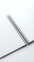 Spiral bound notebook with metal rings on white background, isolated and ready for design use on merchandise and promotional materials.