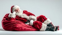 Santa Claus resting peacefully in red velvet suit with white fur trim, sleeping on side against neutral background for holiday marketing campaigns.