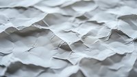 Crumpled white paper texture with waves and shadows creating abstract pattern. Macro view of rough wrinkled surface showing depth and dimension.