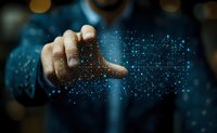 Male hand touching digital network visualization with glowing blue dots and lines connecting in futuristic pattern against dark background. Technology concept.