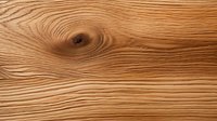 Natural wood grain texture with swirling patterns and knot detail in warm brown tones, macro close-up view showing organic lines and curves in lumber surface.