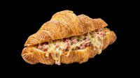 Croissant sandwich with ham and cheese filling, isolated on transparent background. Ready for menu design, food packaging, restaurant graphics, print-on-demand products, and culinary marketing materials.