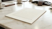 Blank graph paper sheet on wooden desk with coffee cup and office supplies for business planning and data analysis projects.