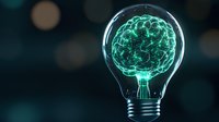 Glowing brain inside light bulb on dark background with bokeh effect, representing creative thinking, innovation, and artificial intelligence technology.