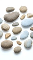 Collection of smooth river stones and pebbles in natural earth tones isolated on white background for spa wellness meditation and zen design projects.