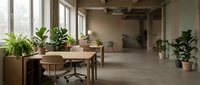 Modern office workspace with wooden desk, ergonomic chair, and potted plants near large windows in minimalist industrial loft setting for contemporary workplace design.