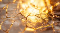 Cracked surface with golden light shining through fissures creating abstract pattern of illuminated veins and textures against dark background.