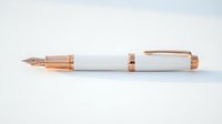 Elegant fountain pen with rose gold metal accents and white barrel, isolated on white background, suitable for stationery, office, and luxury product design projects.
