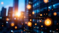 Glowing warm bokeh lights against blurred urban cityscape at dusk, modern glass buildings with soft focus light orbs creating magical atmosphere.