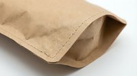 Kraft paper bag with gusset and stitched seam, isolated on white background, ready for packaging, food storage, and retail design applications.