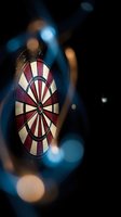Dartboard with red and white segments in atmospheric lighting with bokeh effects for sports and entertainment concepts.