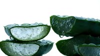 Sliced cucumber with water droplets on white background, isolated fresh vegetable for culinary, food styling, and healthy eating design projects.