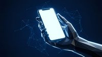 Futuristic hands holding smartphone with blank white screen against digital network background with glowing connections and geometric lines.