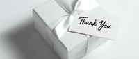 White gift box with elegant satin ribbon bow and thank you card tag, perfect for holiday, wedding, or appreciation greeting designs.