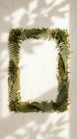 Natural fern and moss frame with shadow patterns on neutral background for botanical design projects and organic branding materials.