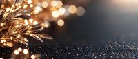 Golden glowing branches with sparkling bokeh lights against dark background create magical festive atmosphere. Elegant holiday design backdrop for seasonal greetings.