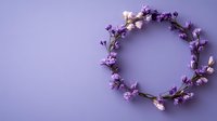 Delicate purple and white floral wreath on soft purple background. Minimalist spring composition with tiny blossoms arranged in circle shape. Wedding decor element.