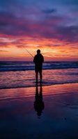 Silhouette of fisherman with rod standing on beach at dramatic sunset with colorful sky reflecting in wet sand and ocean waves for outdoor recreation concepts.