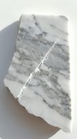 Raw white marble stone fragment with natural gray veining and crack patterns isolated on white background for geology and mineral collection displays.