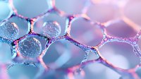 Macro photography of soap bubbles with pink and blue iridescent surface showing hexagonal honeycomb pattern, abstract background with soft focus and light effects.